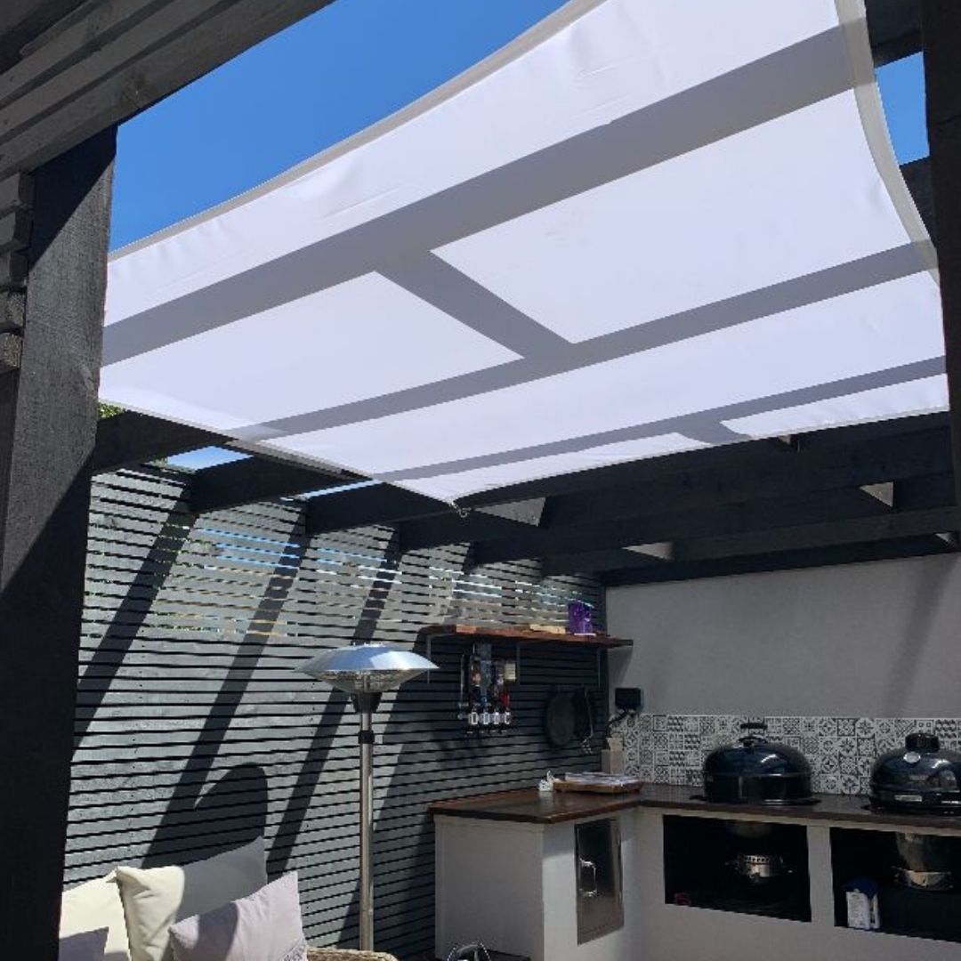 Square shade sail in outdoor kitchen area of garden